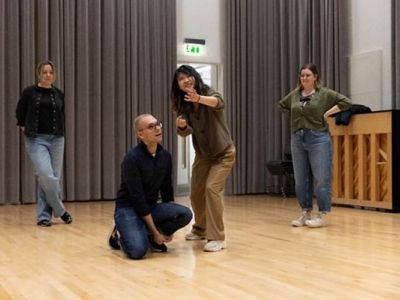 Man and woman acting while others look on